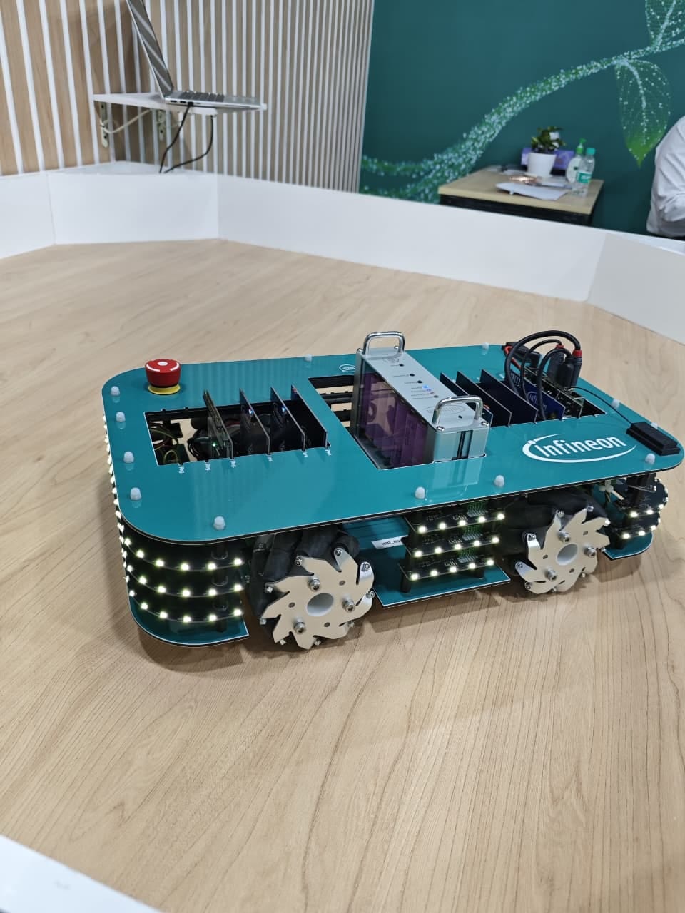Infineon mobile robot with Mecanum wheels and LED strips on a lab floor